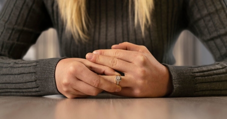Woman taking off her wedding ring as she prepares to file for divorce through Collins Family & Elder Law Group.