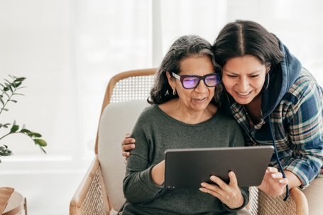 adult woman and mother looking at a tablet