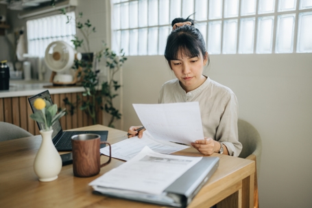 woman poring over documents