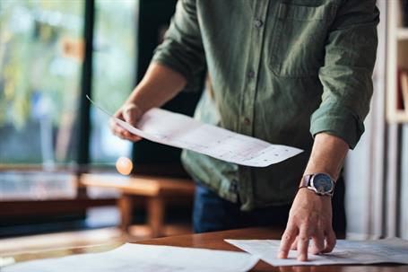 person reviewing documents at home