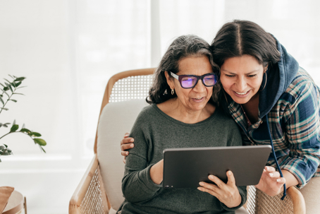 adult woman and mother looking at a tablet